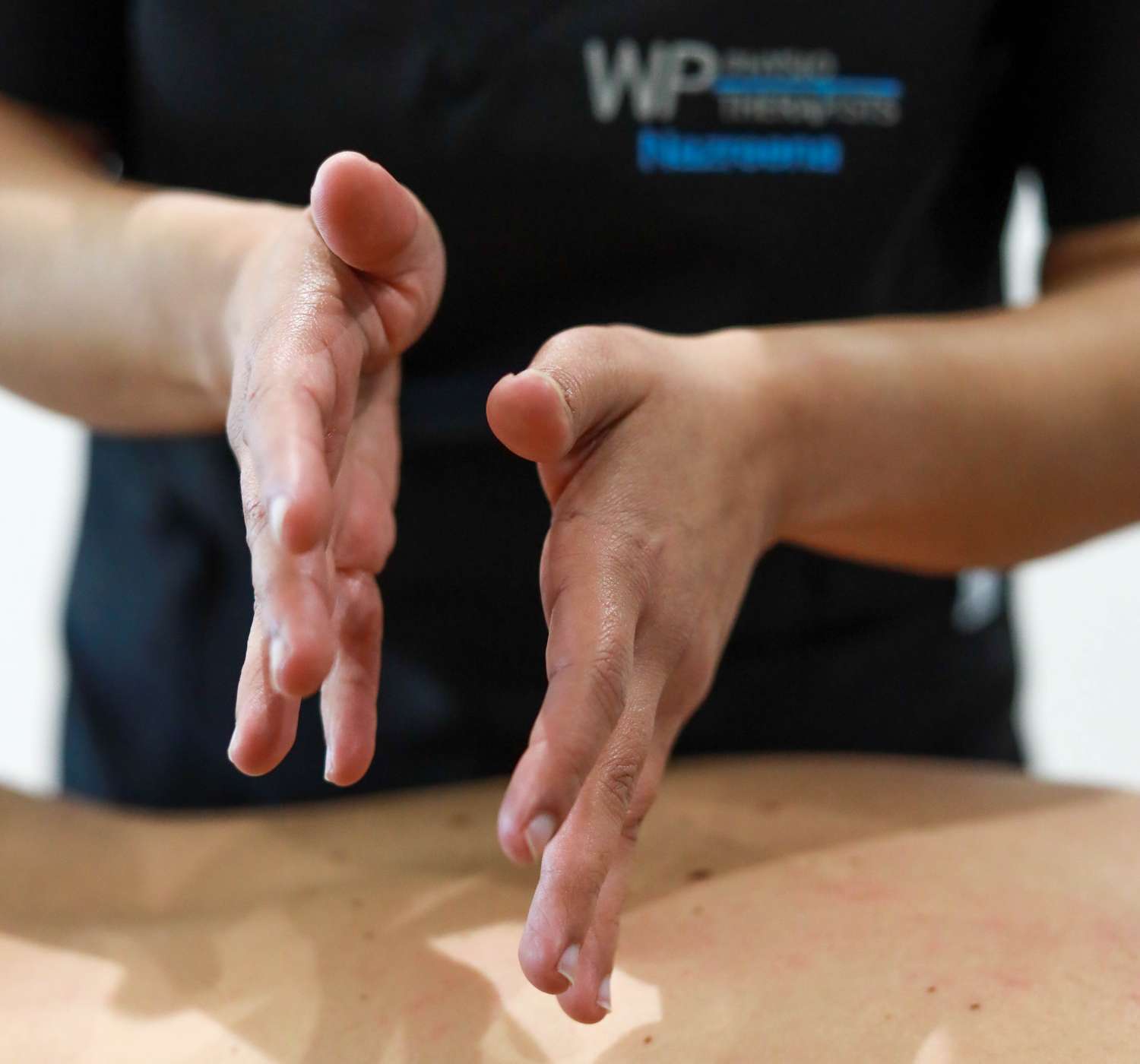 Physiotherapist performing manual treatment on a patient's arm at WP Physiotherapists Gardens